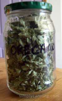 A closed jar filled with dried oregano leaves and labeled accordingly.