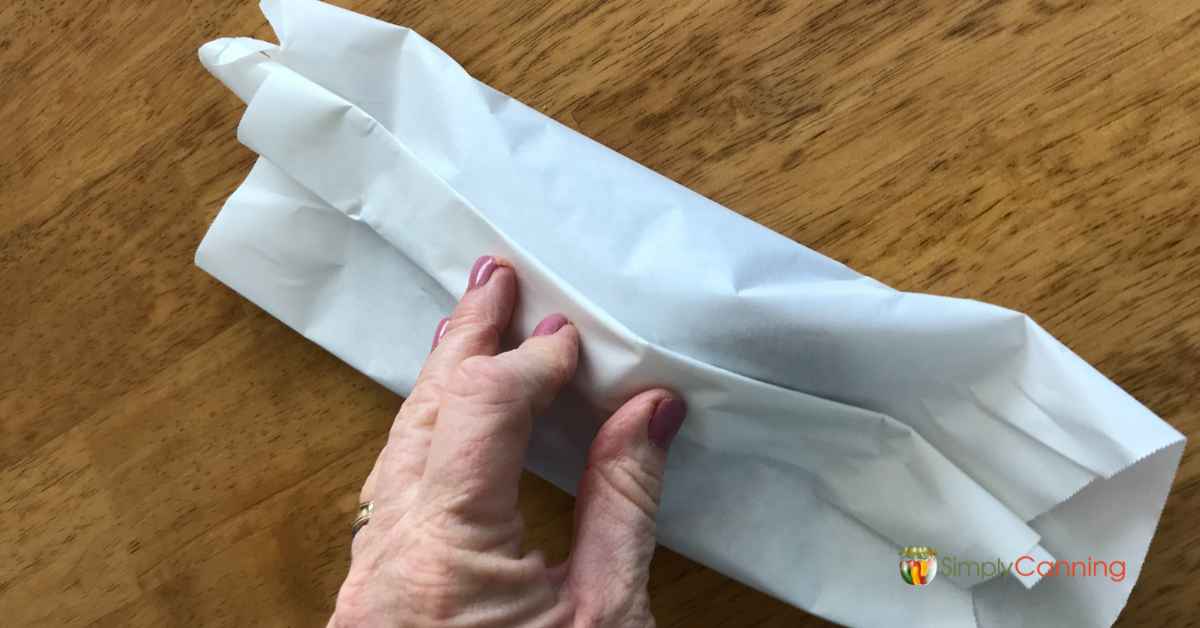 Folding the freezer paper over a piece of meat.]