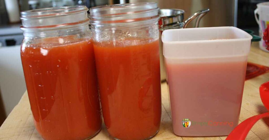 Jars and freezer containers full of tomato sauce.