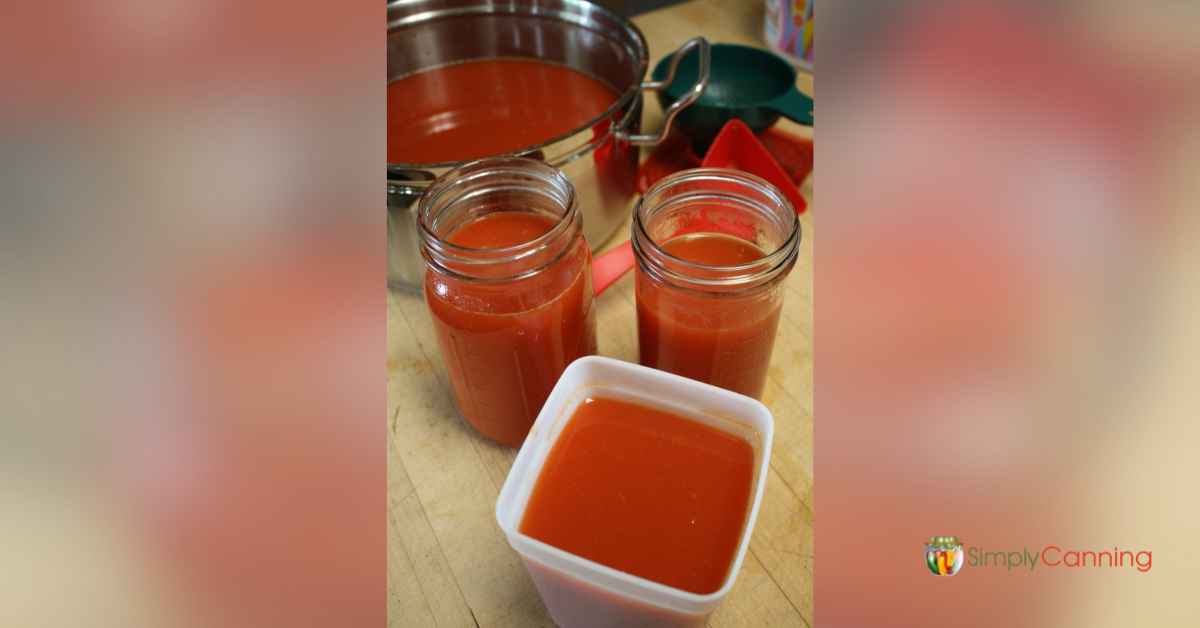 Filling freezer containers with prepared tomato sauce.