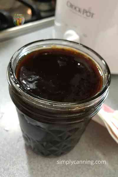 A full canning jar of plum butter.